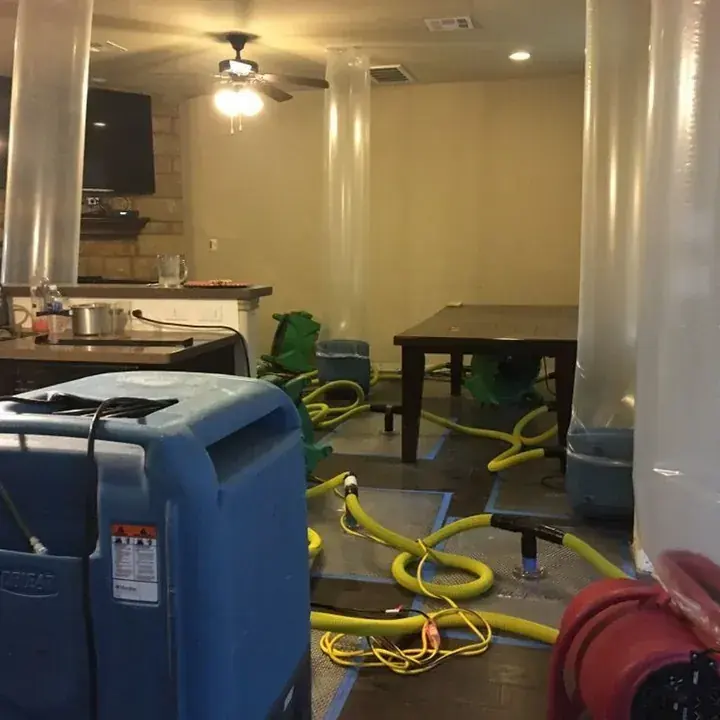 Flood-cut walls drying after a lower-level flood in a Lake Travis Hill Country home